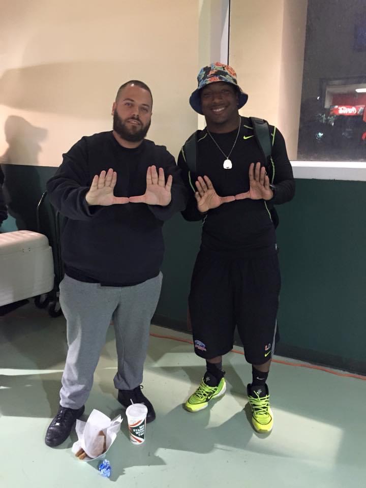 OLI SPORTCARDZ posing with a basketball player