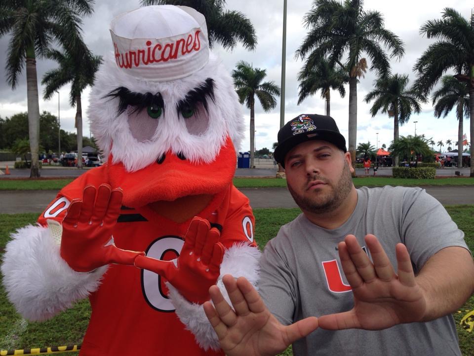 OLI SPORTCARDZ posing with the Miami Hurricanes mascot