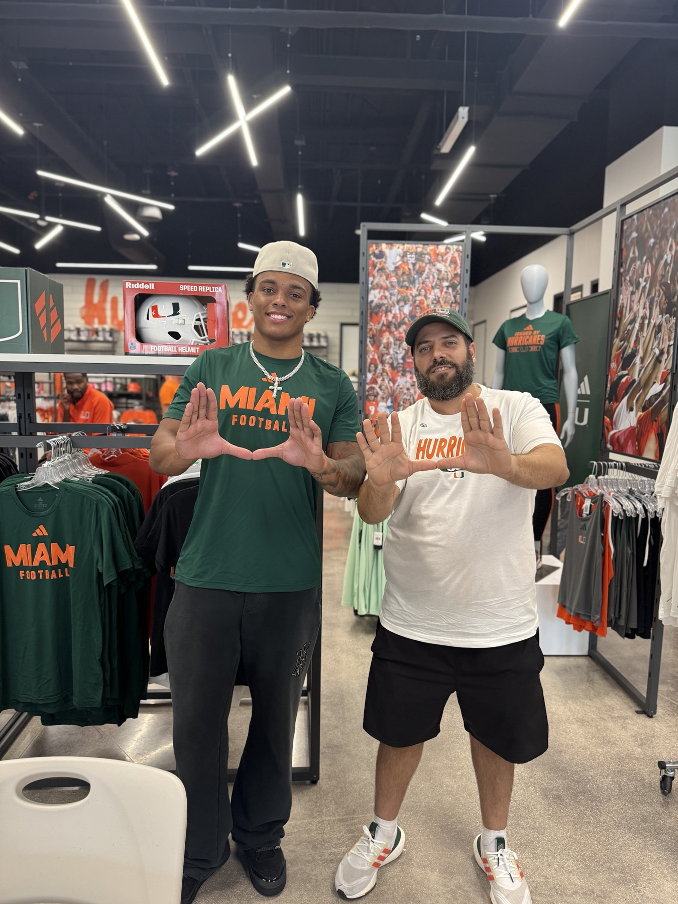 OLI SPORTCARDZ meeting a Miami football player in a team store